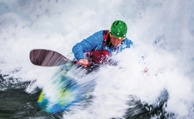 Person kayaking in a drysuit
