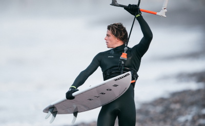 Mystic team riders in their Winter 20/21 wetsuits on the beach